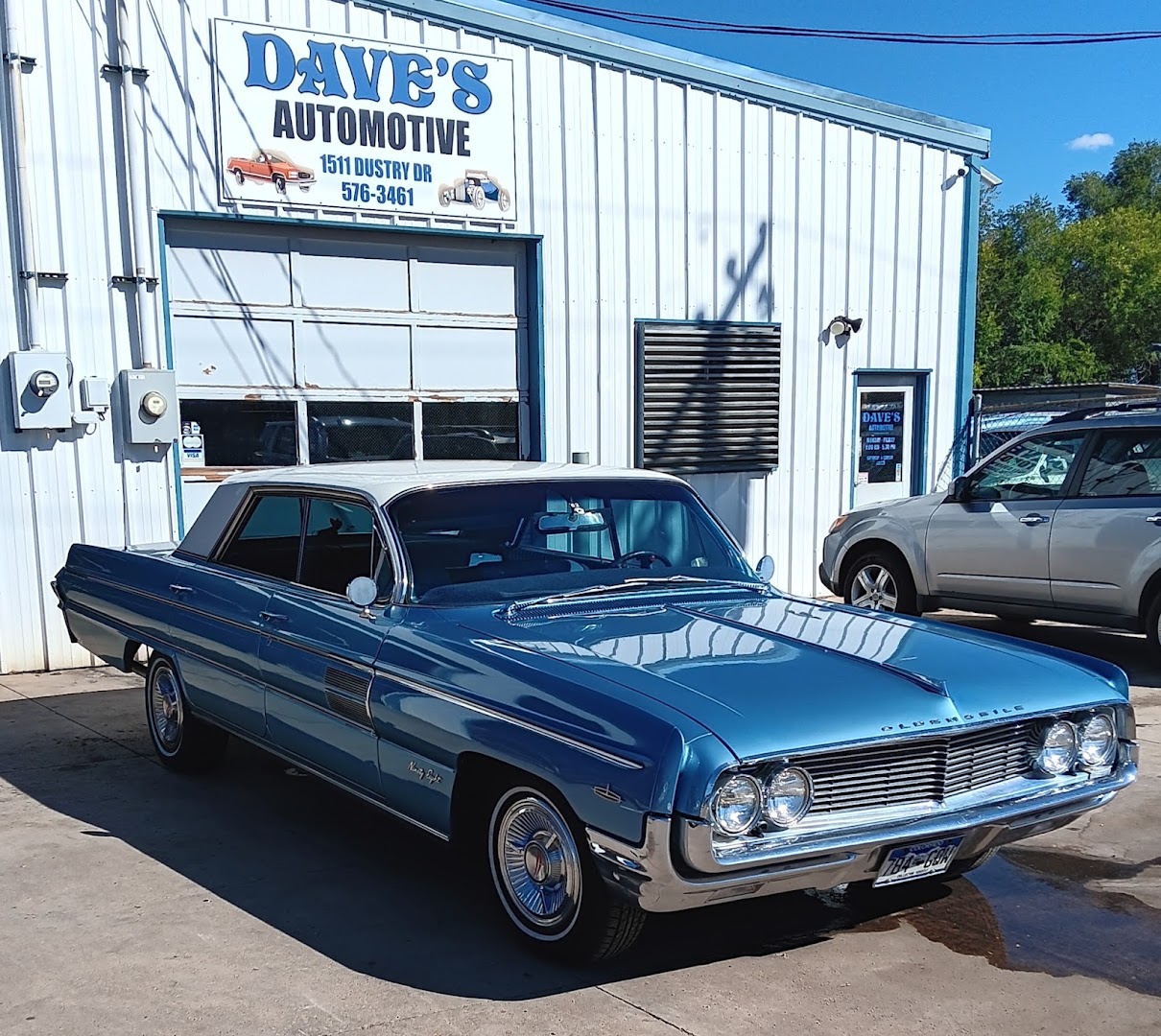 Front of Dave's Automotive Repair with a classic blue Oldsmobile Ninety-Eight parked outside