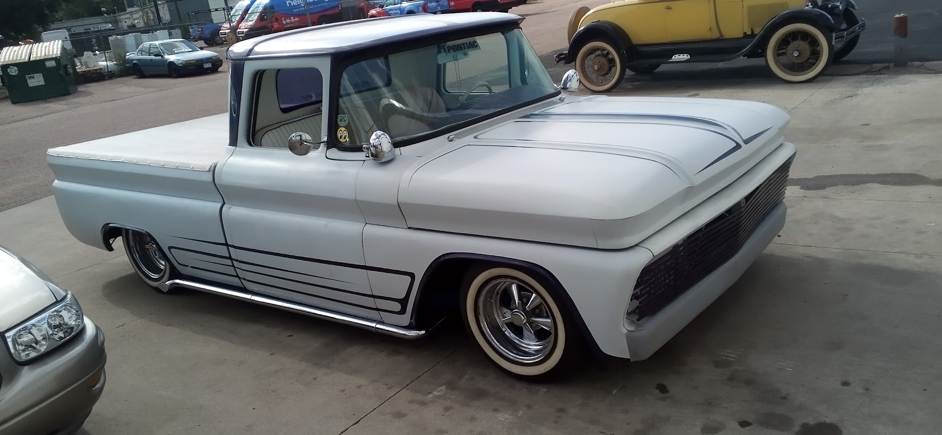 A red Ford F-100 pickup in the shop