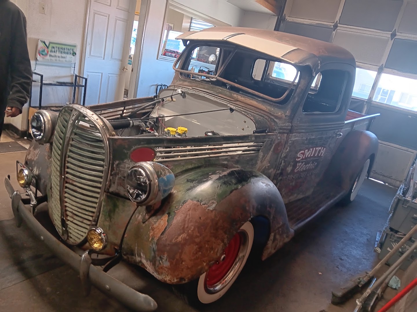 A vintage patina pickup truck inside the garage
